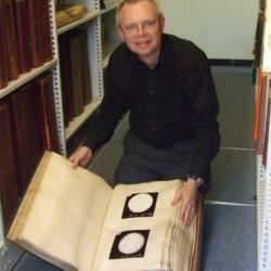 An example of the Sun Picture volumes (man holding large book)